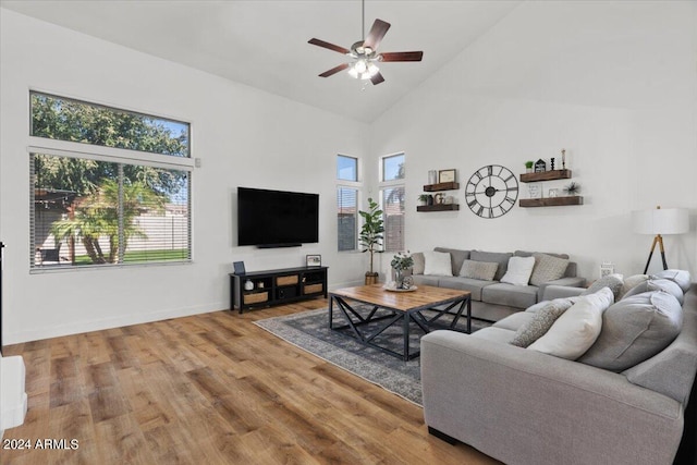 living room featuring a wealth of natural light, wood-type flooring, high vaulted ceiling, and ceiling fan