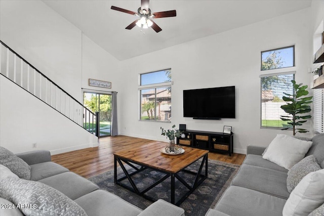 living room featuring a healthy amount of sunlight, dark hardwood / wood-style floors, and high vaulted ceiling