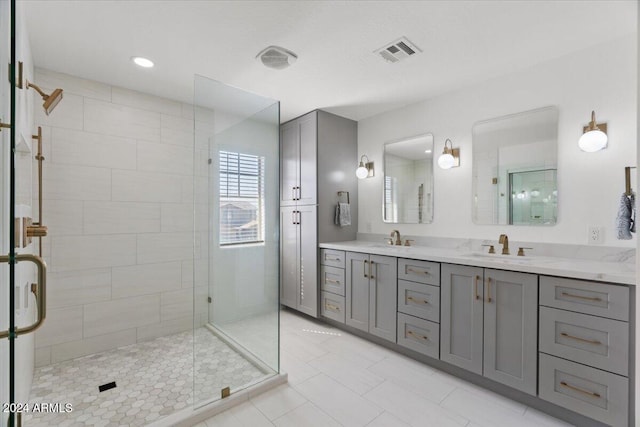 bathroom with vanity, walk in shower, and tile patterned flooring