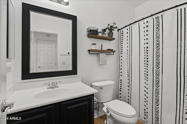 bathroom with vanity, toilet, and a shower with shower curtain