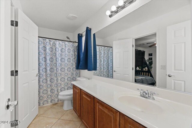 bathroom featuring vanity, ceiling fan, toilet, and tile patterned floors