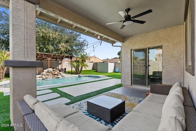 view of patio featuring ceiling fan, pool water feature, a fenced in pool, and outdoor lounge area