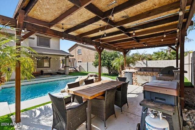 view of patio / terrace featuring an outdoor kitchen, area for grilling, and a fenced in pool