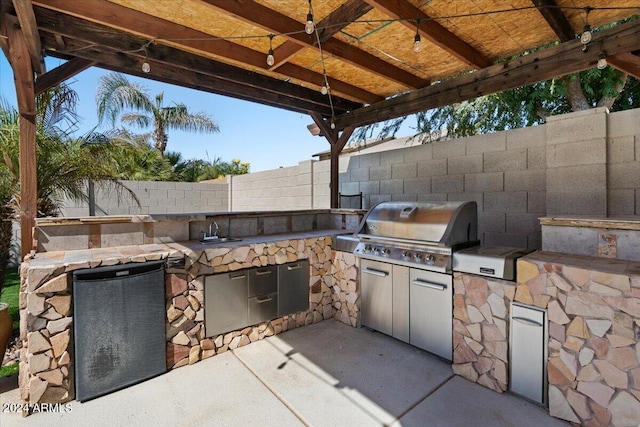 view of patio featuring sink and area for grilling