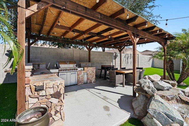 view of patio / terrace with area for grilling, a gazebo, and sink