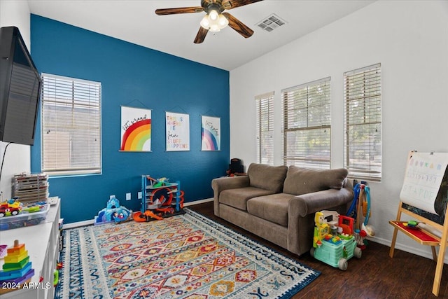 game room featuring dark wood-type flooring, plenty of natural light, and ceiling fan