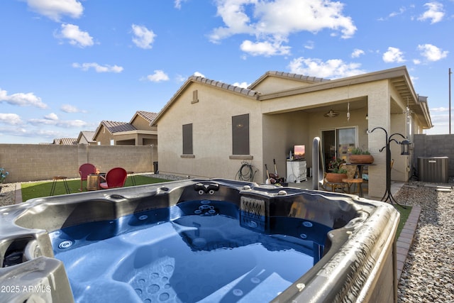1601 S 215th Dr, Buckeye, AZ 85326 - rear view of property with a fenced backyard, cooling unit, stucco siding, and a hot tub
