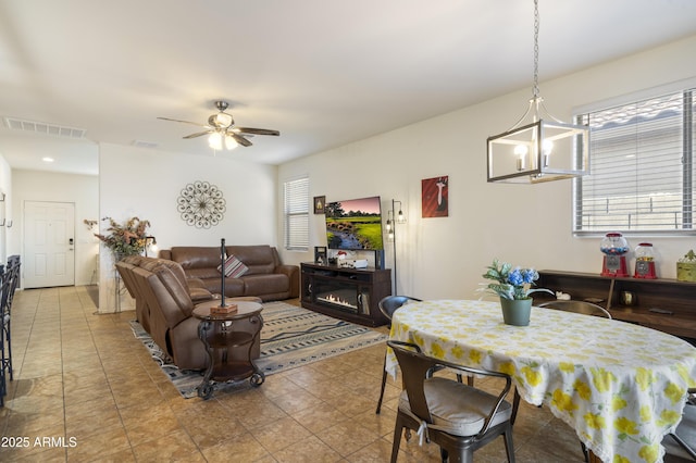1601 S 215th Dr, Buckeye, AZ 85326 - dining room with plenty of natural light, ceiling fan, and light tile patterned floors