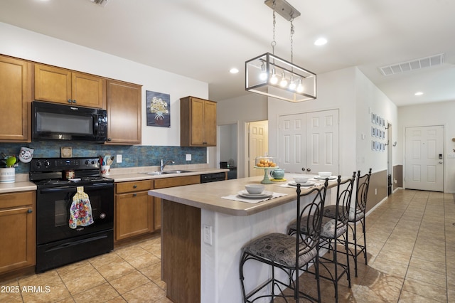 1601 S 215th Dr, Buckeye, AZ 85326 - kitchen with black appliances, light tile patterned floors, decorative backsplash, brown cabinets, and recessed lighting