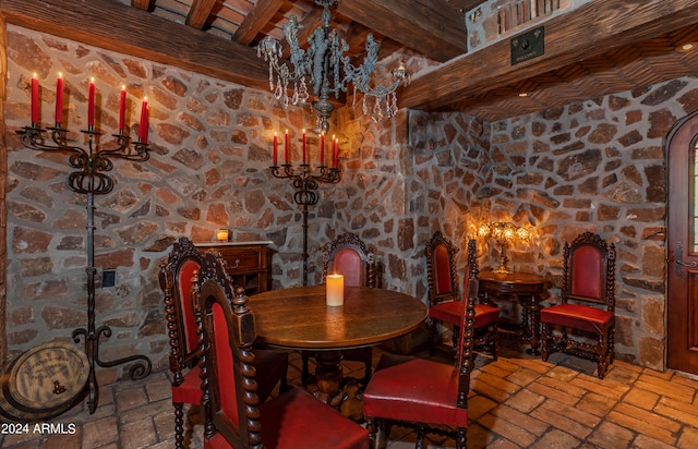 dining area featuring beamed ceiling