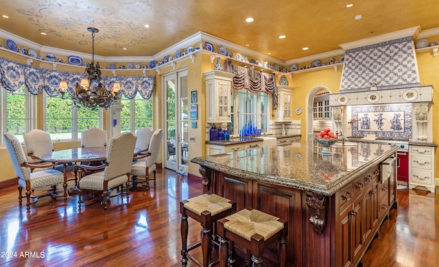 kitchen featuring hanging light fixtures, crown molding, and a kitchen island