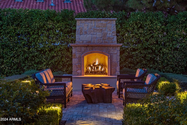 view of patio featuring an outdoor stone fireplace