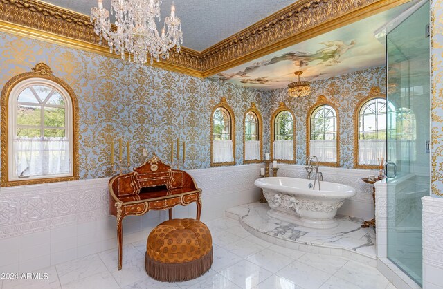 bathroom featuring ornamental molding, shower with separate bathtub, a notable chandelier, and a textured ceiling