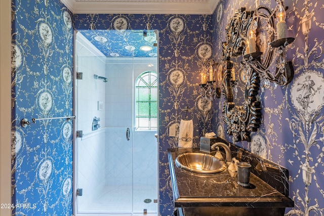 bathroom with walk in shower, vanity, and crown molding