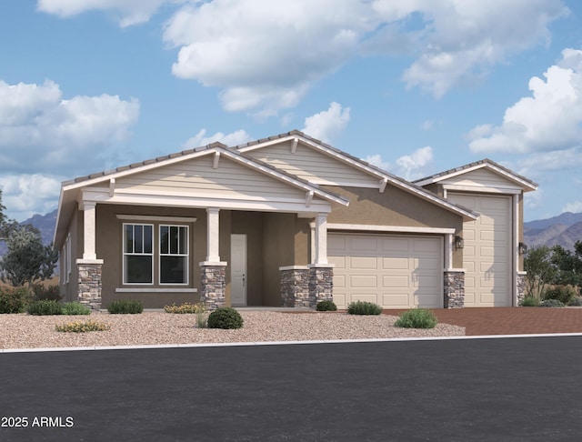 craftsman-style house featuring stucco siding, a mountain view, a garage, stone siding, and driveway