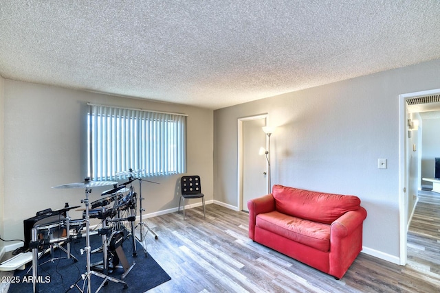 3209 W Charleston Ave, Phoenix, AZ 85053 - interior space with a textured ceiling, visible vents, wood finished floors, and baseboards