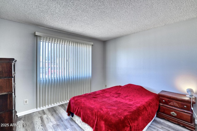 3209 W Charleston Ave, Phoenix, AZ 85053 - bedroom featuring baseboards, wood finished floors, and a textured ceiling