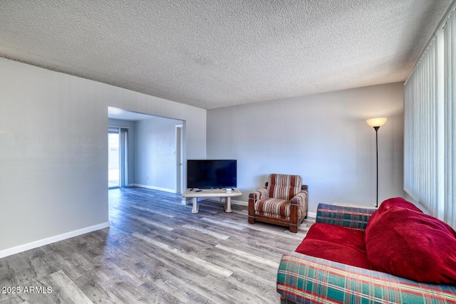 3209 W Charleston Ave, Phoenix, AZ 85053 - living area with a textured ceiling, wood finished floors, and baseboards