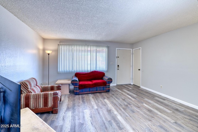 3209 W Charleston Ave, Phoenix, AZ 85053 - living room with a textured ceiling, wood finished floors, and baseboards