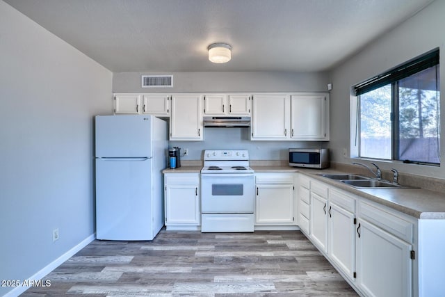 3209 W Charleston Ave, Phoenix, AZ 85053 - kitchen with white cabinetry, a sink, visible vents, under cabinet range hood, and white appliances