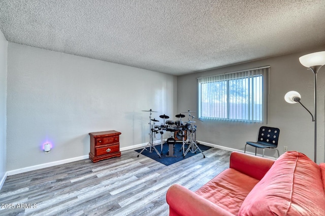 3209 W Charleston Ave, Phoenix, AZ 85053 - living area with baseboards, wood finished floors, and a textured ceiling