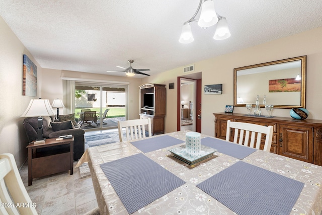 dining area featuring ceiling fan and a textured ceiling