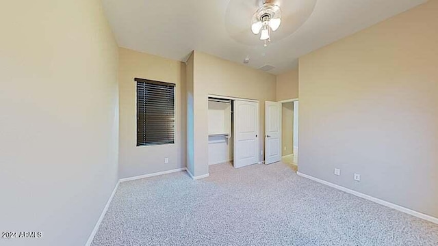 unfurnished bedroom with light colored carpet, a closet, and ceiling fan