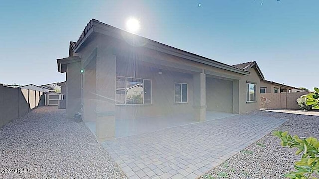 view of side of home with a patio area