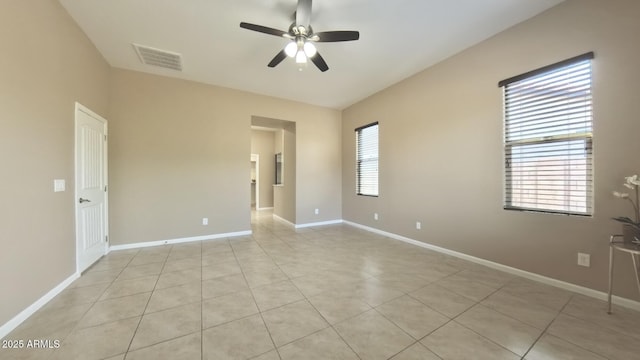 spare room featuring ceiling fan and light tile patterned floors