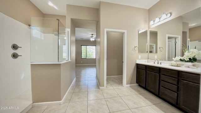 bathroom featuring walk in shower, ceiling fan, vanity, and tile patterned flooring