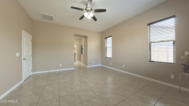 tiled spare room featuring ceiling fan