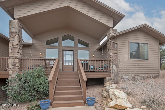 view of exterior entry featuring a wooden deck