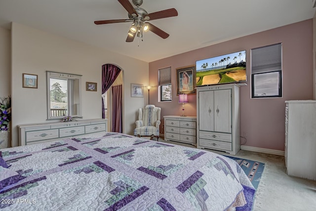 carpeted bedroom featuring baseboards and a ceiling fan