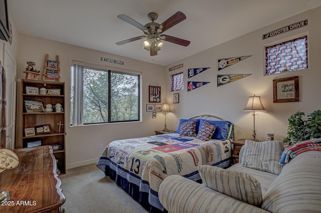 bedroom with carpet, a ceiling fan, and baseboards