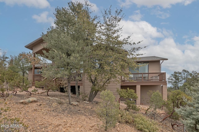 rear view of property featuring a deck