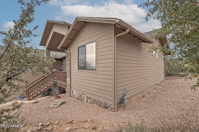 view of side of property featuring stairs