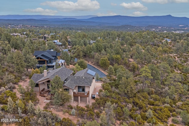 aerial view featuring a mountain view and a wooded view