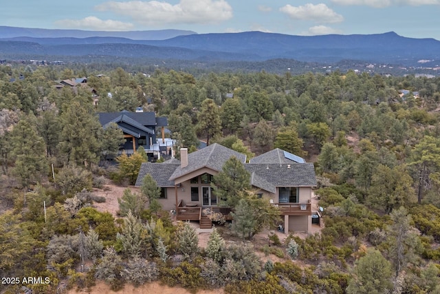 aerial view featuring a forest view and a mountain view