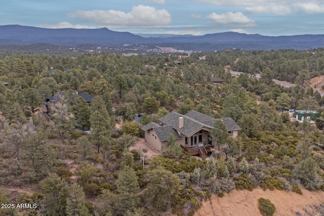 drone / aerial view featuring a mountain view and a wooded view