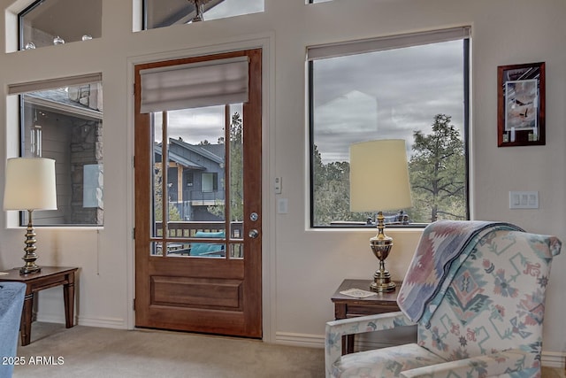 entryway with carpet floors and baseboards