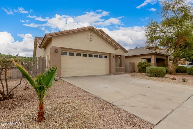 view of front of property featuring a tile roof, stucco siding, concrete driveway, and a garage