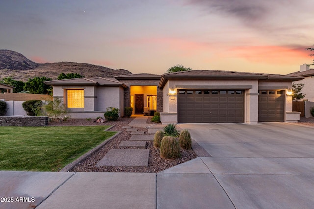 4618 W Pokeberry Ln, Phoenix, AZ 85083 - prairie-style home with an attached garage, concrete driveway, a front lawn, a mountain view, and stucco siding