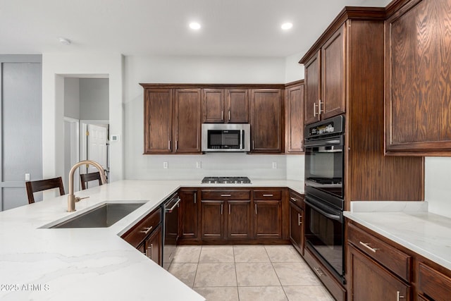 4618 W Pokeberry Ln, Phoenix, AZ 85083 - kitchen featuring stainless steel appliances, light stone countertops, light tile patterned floors, recessed lighting, and dark brown cabinetry