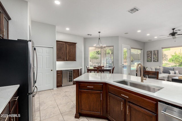 4618 W Pokeberry Ln, Phoenix, AZ 85083 - kitchen with appliances with stainless steel finishes, wine cooler, light countertops, open floor plan, and recessed lighting