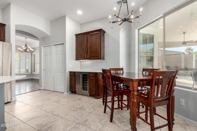 4618 W Pokeberry Ln, Phoenix, AZ 85083 - dining area featuring a chandelier, beverage cooler, light tile patterned floors, arched walkways, and recessed lighting