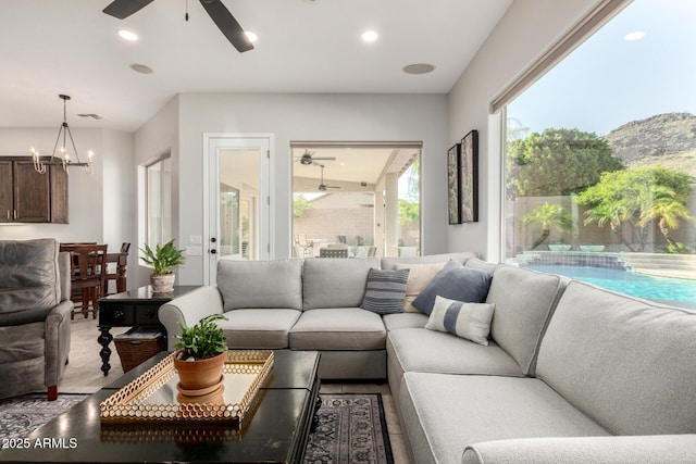4618 W Pokeberry Ln, Phoenix, AZ 85083 - living room featuring ceiling fan, a chandelier, a mountain view, and recessed lighting