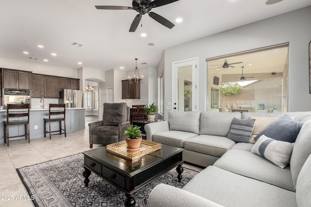 4618 W Pokeberry Ln, Phoenix, AZ 85083 - living area featuring a chandelier, ceiling fan, recessed lighting, light tile patterned flooring, and arched walkways