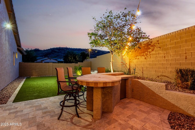 4618 W Pokeberry Ln, Phoenix, AZ 85083 - patio terrace at dusk with a fenced backyard and a patio area