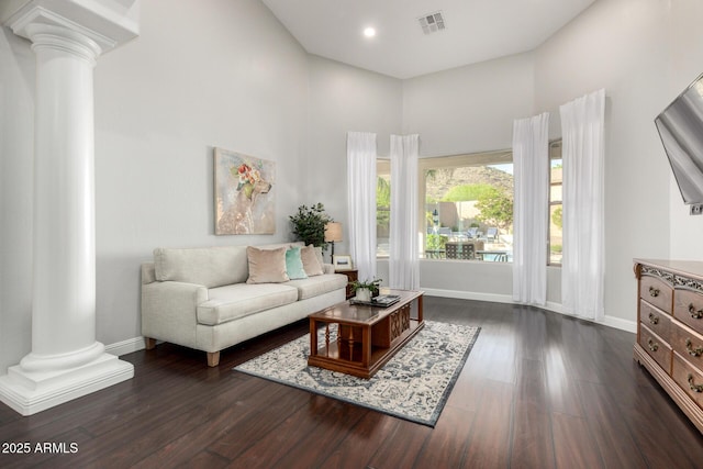 4618 W Pokeberry Ln, Phoenix, AZ 85083 - living area featuring ornate columns, a towering ceiling, dark wood-type flooring, and recessed lighting