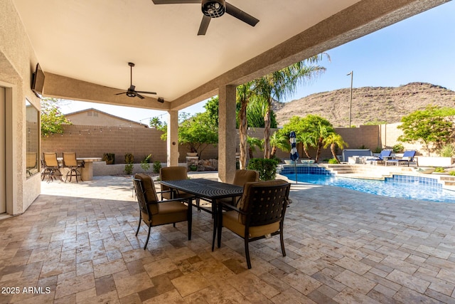 4618 W Pokeberry Ln, Phoenix, AZ 85083 - fenced backyard with a mountain view, outdoor dining area, a ceiling fan, and a patio